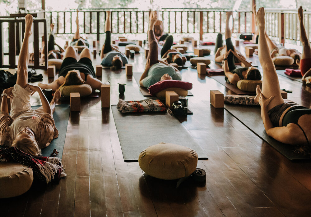 A group of people in a yoga class in an outdoor space